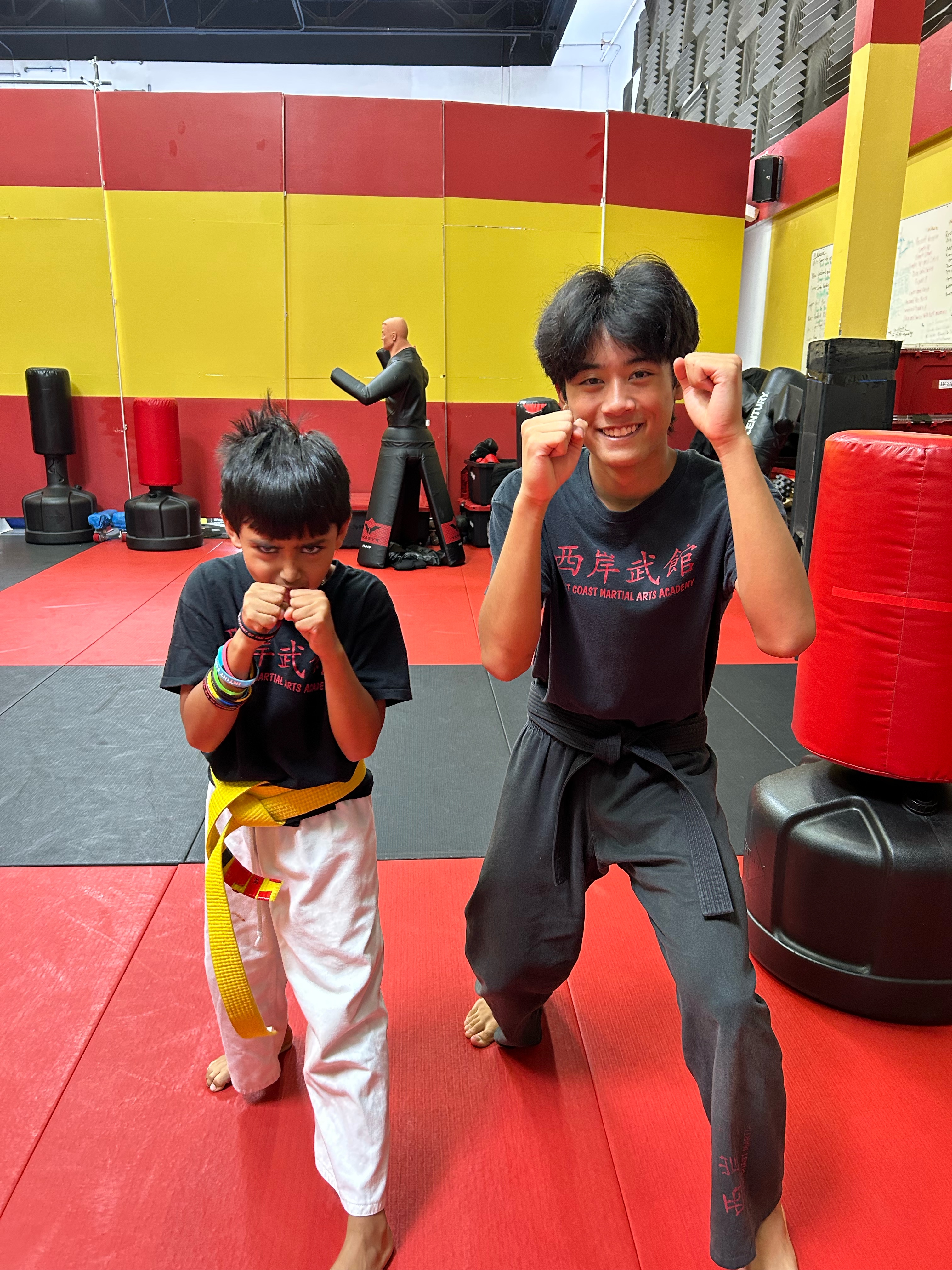 Aiden Nelson on the mat with a young Blur Martial Arts student