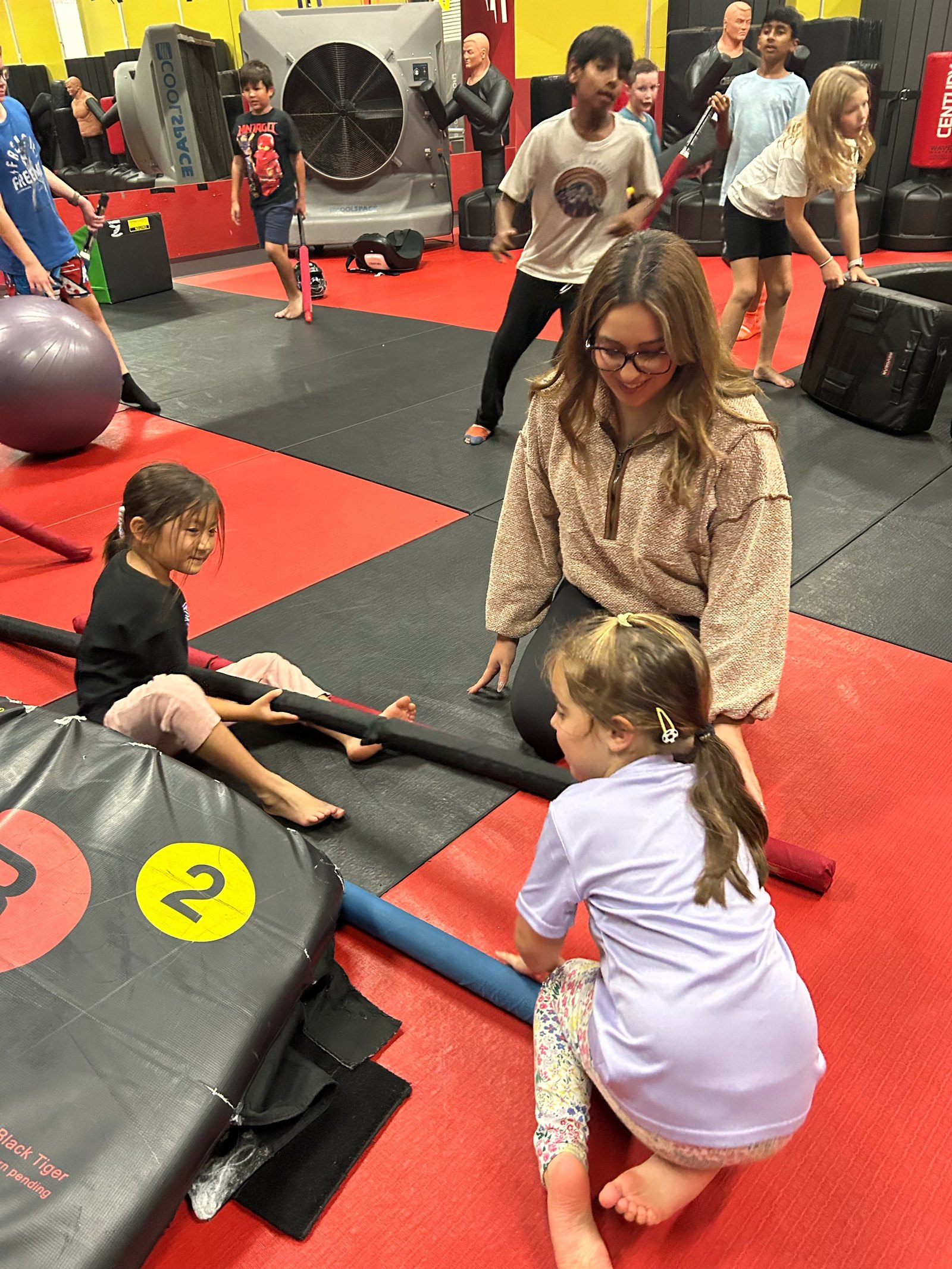 Hala leading a youth activity on the Blur Martial Arts mat